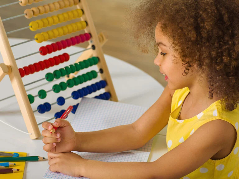 Little girl working on math at home